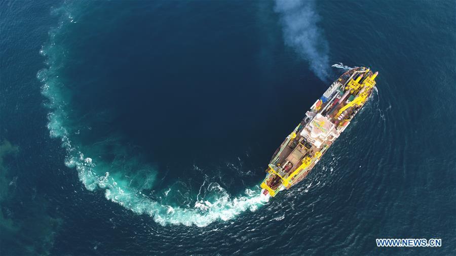 Tian Kun Hao, a Chinese-built dredging vessel, the largest of its kind in Asia, sails under a sea trial after departing a port in east China\'s Jiangsu Province, June 11, 2018. Tian Kun Hao, constructed by Tianjin Dredging Co. Ltd., a subsidiary of China Communication Construction Co., Ltd. (CCCC), finished its first sea trial. The 140-meter-long vessel, with the designed capacity to dredge 6,000 cubic meters per hour, can dig as deep as 35 meters under the sea floor. (Xinhua/Mao Zhenhua)