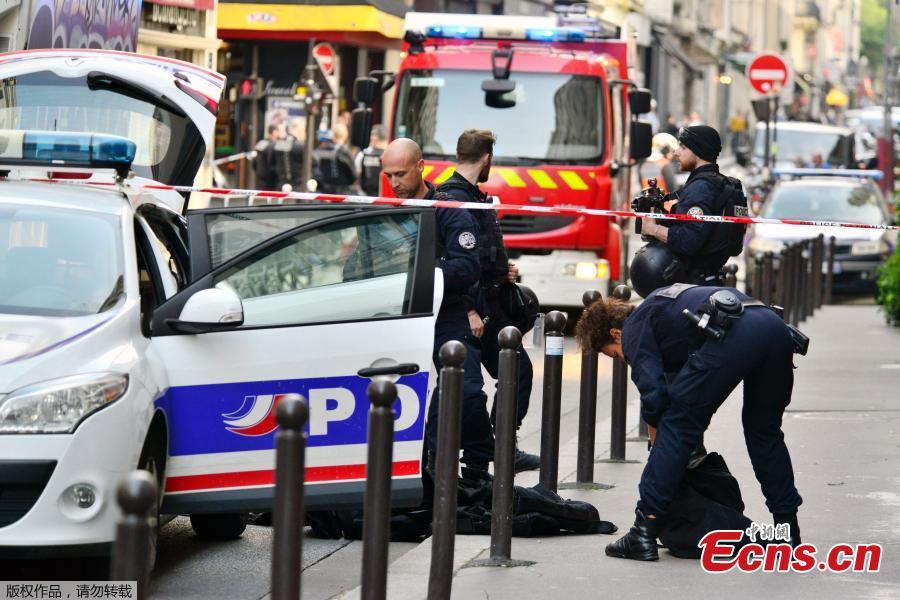 Photo taken on June 12, 2018 shows French police and firemen secure the street as a man has taken people hostage at a business in Paris, France. Police rescued two hostages and arrested a man in central Paris after he demanded to be put in touch with the Iranian Embassy to deliver a message to the French government, authorities said. (Photo: China News Service/Long Jianwu)
