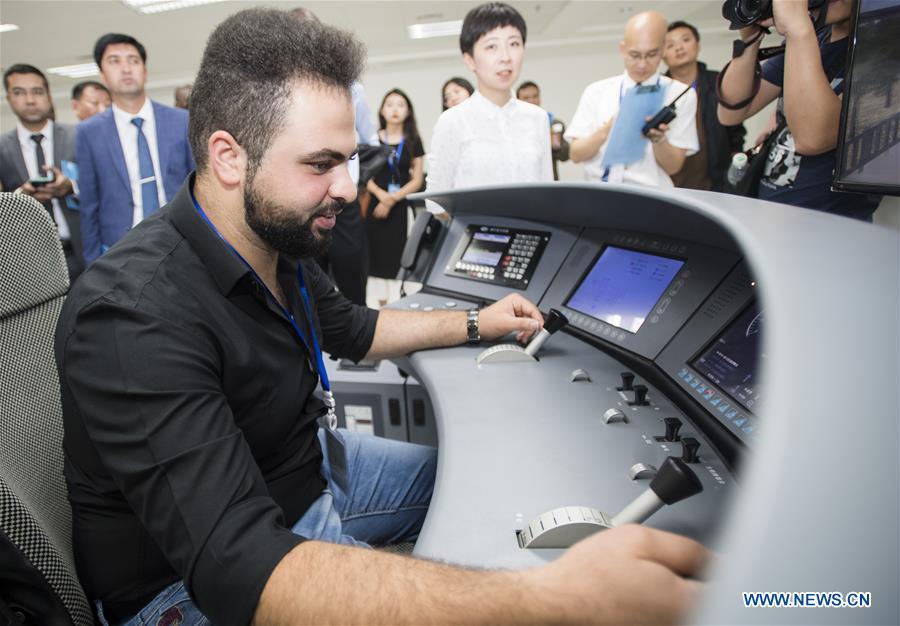 A railway executive from Jordan experiences a simulation of high-speed train driving at a training base for high-speed railway staff in Wuhan, central China\'s Hubei Province, June 12, 2018. Altogether 63 railway executives from 13 countries including Thailand, Sri Lanka and Laos visited the training base Tuesday. (Xinhua/Xiao Yijiu)