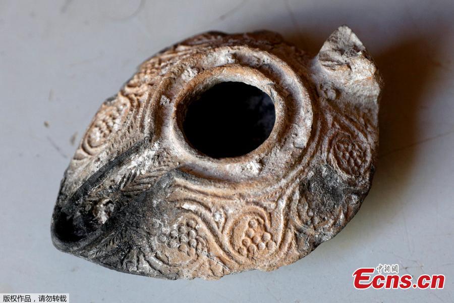 Israeli archaeologists have unearthed a rare 1,000-year-old clay amulet bearing an inscription in Arabic at a parking lot in the East Jerusalem, Israel\'s antiquities authority said Thursday, June 14, 2018. The tiny object, which has a diameter of less than 1 centimeter, was dug up at the Givati Parking Lot just outside Jerusalem\'s Old City, and is inscribed with the following two-line personal prayer: \