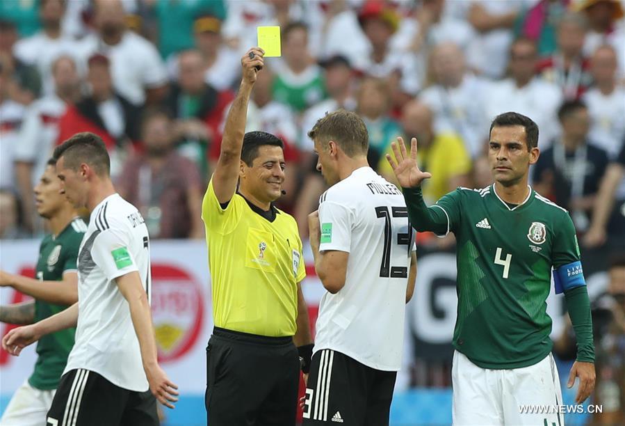 The referee gives a yellow card to Thomas Mueller (2nd R) of Germany during a group F match between Germany and Mexico at the 2018 FIFA World Cup in Moscow, Russia, June 17, 2018. (Xinhua/Xu Zijian)