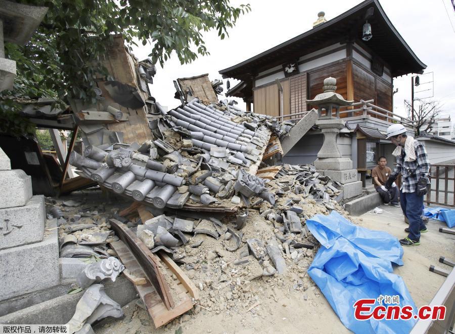 The gate of Myotoku-ji temple collapses after an earthquake hit Ibaraki City, Osaka, western Japan, Monday, June 18, 2018. A magnitude 6.1 earthquake shook Osaka, Japan’s second-biggest metropolis, early on Monday, killing three people, halting factory lines in an industrial area and bursting water mains, government and company officials said. (Photo/Agencies)