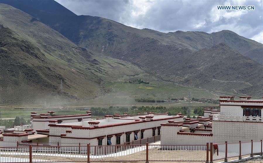 This photo taken on June 18, 2018 shows residences built for villagers who have moved from Nyima County of Nagqu to the new settlement in Lhasa during a relocation program with environmental purposes in southwest China\'s Tibet Autonomous Region. A total of 1,102 residents have been relocated to a new settlement in Lhasa to make their old neighbourhoods accessible to wild animals in the Qiangtang National Nature Reserve. Completed on Monday, the relocation marked the first such program carried out for the sake of environmental protection in areas at high altitudes in Tibet Autonomous Region. (Xinhua/Chogo)