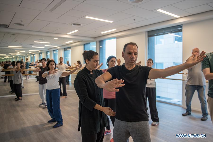 Israelis learn Tai Chi at the Chinese Cultural Center in Tel Aviv, Israel, on June 18, 2018. The Chinese Cultural Center provides locals with a series of courses introducing Chinese culture. (Xinhua/Guo Yu)
