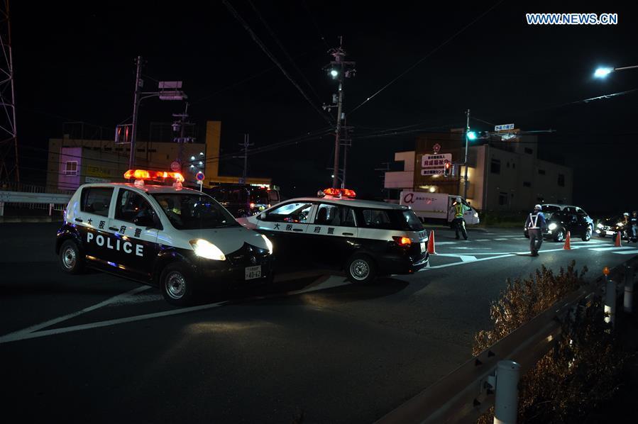 Policemen lead vehicles away at a site of a damaged road in Osaka, Japan, on June 18, 2018. At least three people have been confirmed dead and more than 90 others injured as a result of a 6.1 magnitude earthquake striking Osaka prefecture in western Japan on Monday morning. (Xinhua/Ma Ping)