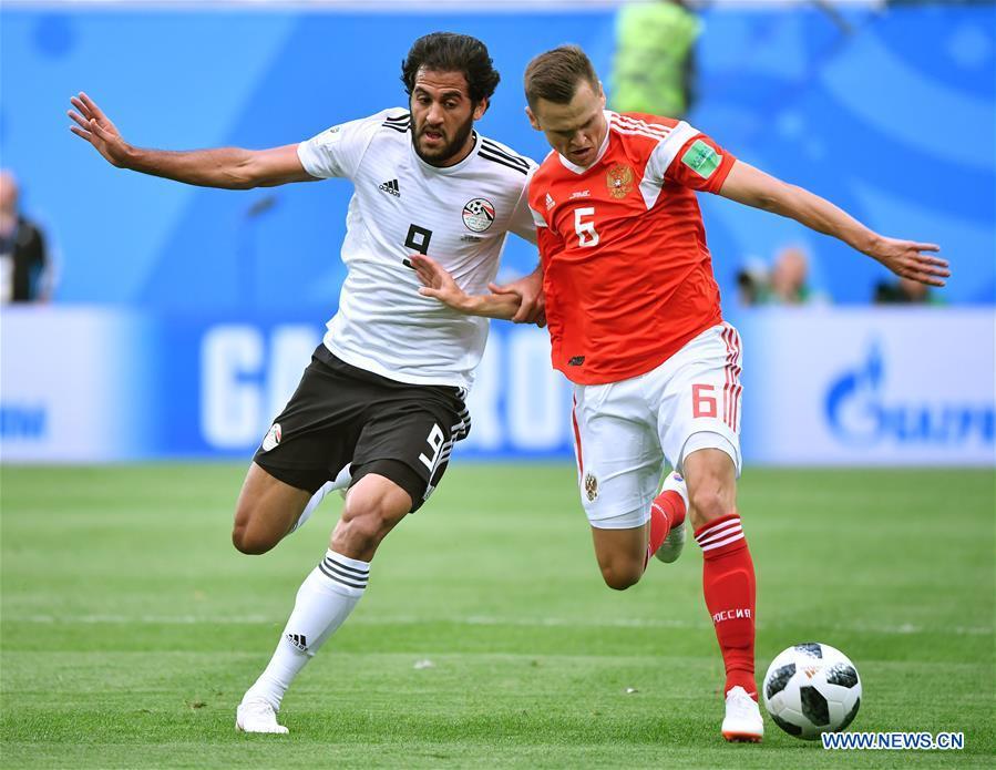 Denis Cheryshev (R) of Russia vies with Marwan Mohsen of Egypt during a Group A match between Russia and Egypt at the 2018 FIFA World Cup in Saint Petersburg, Russia, June 19, 2018. (Xinhua/Li Ga)