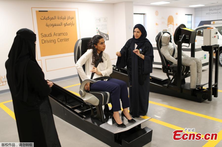 A driving instructor (R) explains seat bells to trainees Amira Abdulgader and Maria Al-Faraj (C) at Saudi Aramco Driving Center in Dhahran, Saudi Arabia, June 6, 2018. (Photo/Agencies)