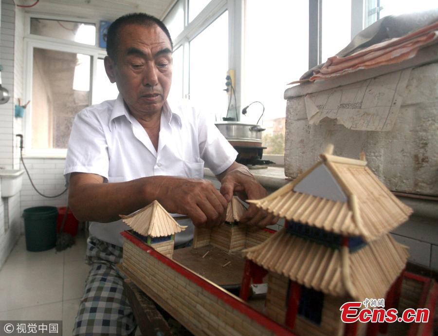 Yu Zuofu, an enthusiast of miniature buildings and landscapes, shows his creation in Anshan City, Liaoning Province. Yu, 79, developed the interest in making very small buildings with waste chopsticks or ice lolly sticks after his retirement. Among the more than 200 miniature creations, his first work was a replica of Daguanyuan, or Grand View Garden, depicted in the classical novel Dream of the Red Chamber. (Photo/VCG)