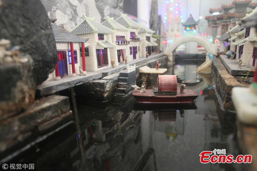 Yu Zuofu, an enthusiast of miniature buildings and landscapes, shows his creation in Anshan City, Liaoning Province. Yu, 79, developed the interest in making very small buildings with waste chopsticks or ice lolly sticks after his retirement. Among the more than 200 miniature creations, his first work was a replica of Daguanyuan, or Grand View Garden, depicted in the classical novel Dream of the Red Chamber. (Photo/VCG)