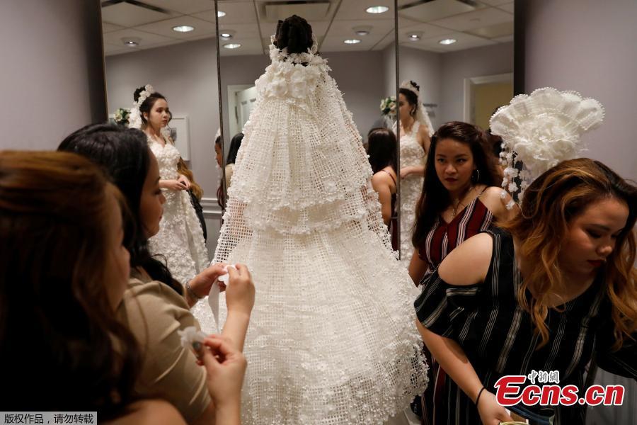 A model is fitted for the 14th Annual Toilet Paper Wedding Dress Contest in Manhattan, New York, U.S., June 20, 2018. (Photo/Agencies)