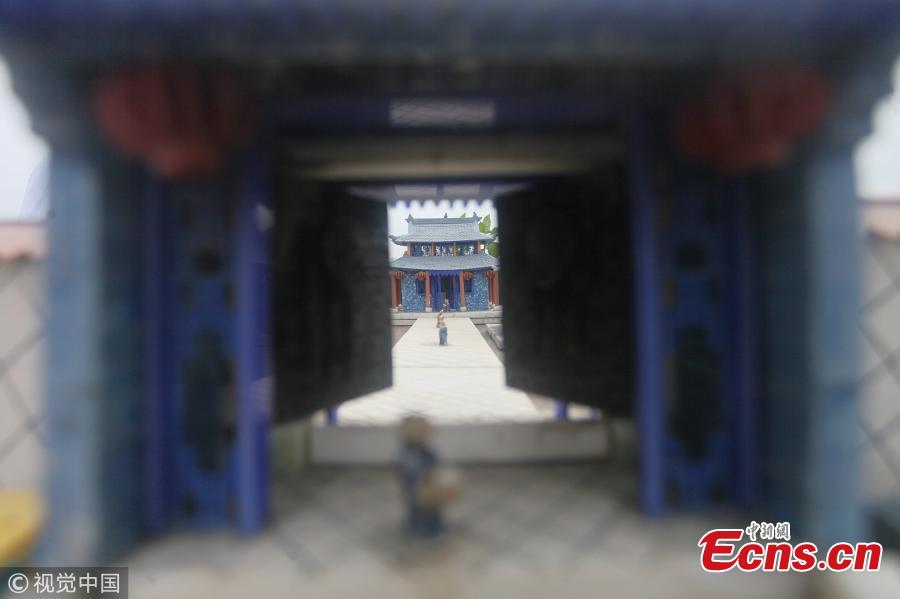 Yu Zuofu, an enthusiast of miniature buildings and landscapes, shows his creation in Anshan City, Liaoning Province. Yu, 79, developed the interest in making very small buildings with waste chopsticks or ice lolly sticks after his retirement. Among the more than 200 miniature creations, his first work was a replica of Daguanyuan, or Grand View Garden, depicted in the classical novel Dream of the Red Chamber. (Photo/VCG)