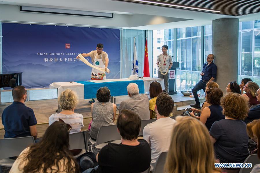 Chinese chef Jiang Bo (C) demonstrates noodle making skill during a Chinese food festival event at the Chinese Cultural Center in Tel Aviv, Israel, on June 22, 2018. (Xinhua/Guo Yu)