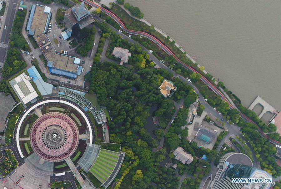 Aerial photo taken on May 14, 2017 shows a riverside path of the Lujiazui area in Pudong of Shanghai, east China. China announced the opening-up and development of Pudong in 1990. Pudong is expecting to take the opportunity of celebrating the 40th anniversary of China\'s reform and opening-up to continue to spearhead the country\'s reform and development. (Xinhua/Ding Ting)