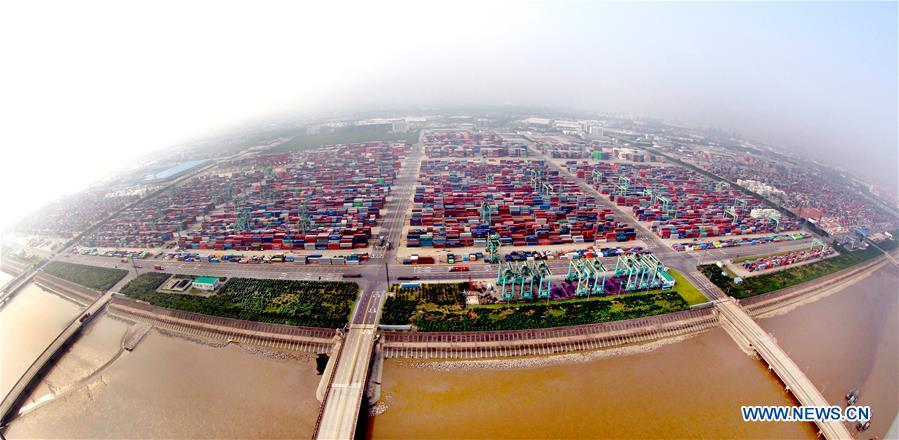 Aerial photo taken on Sept. 29, 2014 shows the Waigaoqiao container pier of Shanghai free trade zone (FTZ) in Pudong of Shanghai, east China. China announced the opening-up and development of Pudong in 1990. Pudong is expecting to take the opportunity of celebrating the 40th anniversary of China\'s reform and opening-up to continue to spearhead the country\'s reform and development. (Xinhua/Fan Jun)