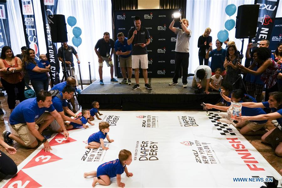 Babies participate in the Diaper Derby 2018 in New York, the United States, June 29, 2018. Diaper Derby 2018, a baby crawling contest, was held here on Friday. Around 30 babies competed to crawl across a 12-foot (3.66 meters) long mat. (Xinhua/Lin Bilin)