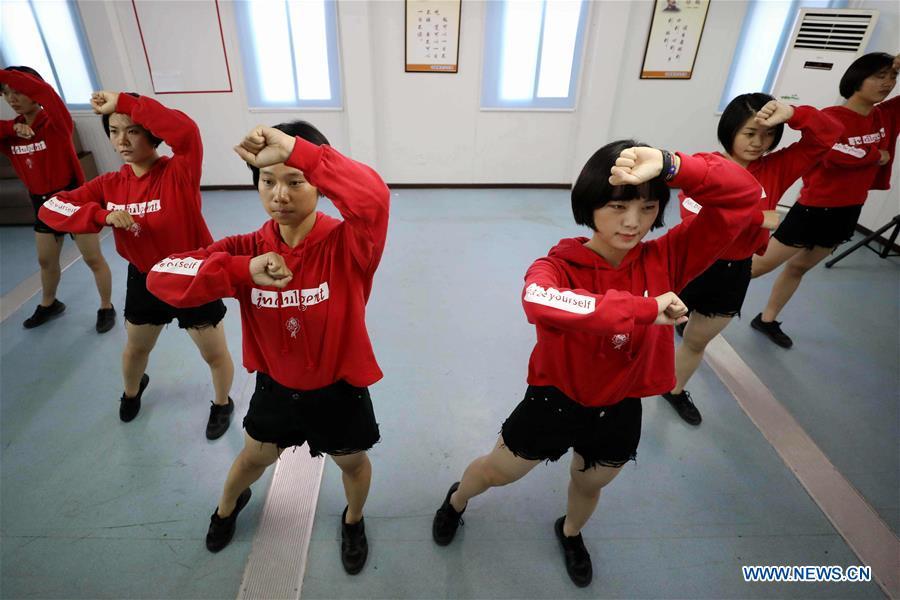 Chinese peacekeeper Yu Peijie (3rd L) dances with fellow soldiers in a gym at the camp of Chinese peacekeeping infantry batallion to South Sudan on April 30, 2018. Yu Peijie, 26-year-old, is the monitor of the female peacekeeper team of Chinese peacekeeping infantry batallion to South Sudan. She has a nickname called \