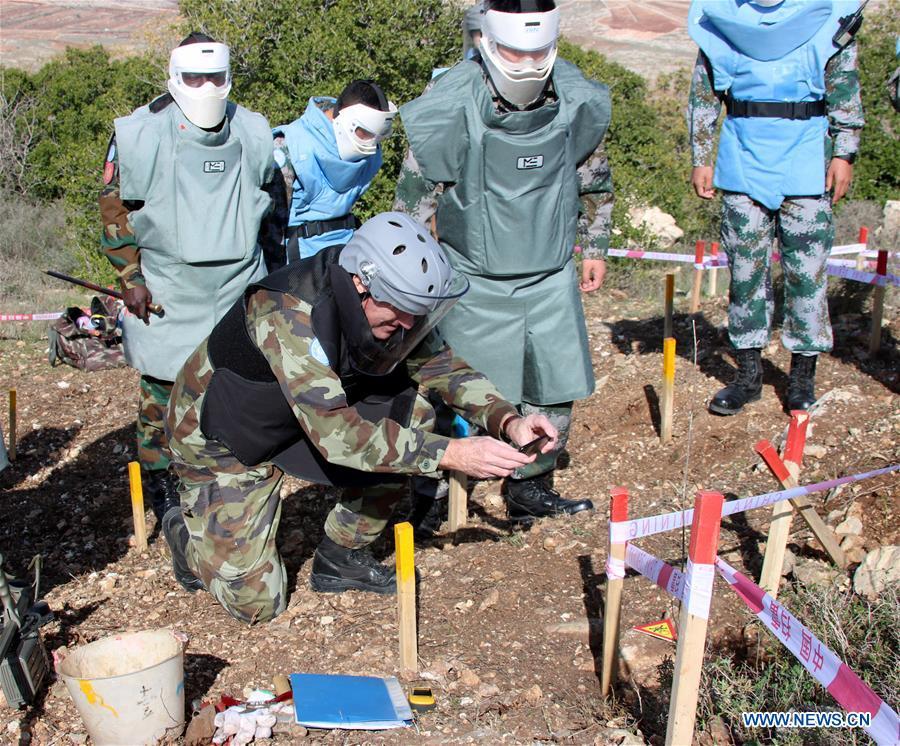 The photo taken on Dec. 15, 2017 shows Maj. Gen. Michael Beary, head of Mission and Force Commander of the United Nations Interim Force in Lebanon, taking photos of a removed mine at a minefield near the UN demarcated \