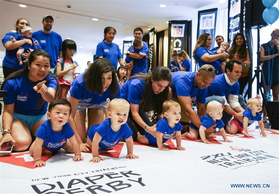 Babies participate in the Diaper Derby 2018 in New York, the United States, June 29, 2018. Diaper Derby 2018, a baby crawling contest, was held here on Friday. Around 30 babies competed to crawl across a 12-foot (3.66 meters) long mat. (Xinhua/Lin Bilin)