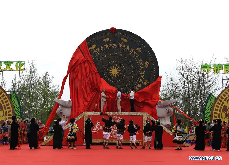 People unveil a gigantic bronze drum in Huanjiang Maonan Autonomous County, south China\'s Guangxi Zhuang Autonomous Region, June 29, 2018. The drum measures 6.68 meters in diameter and weighs 50 tons. It was recognized as the largest bronze drum by Guinness World Records. (Xinhua/Zhou Hua)