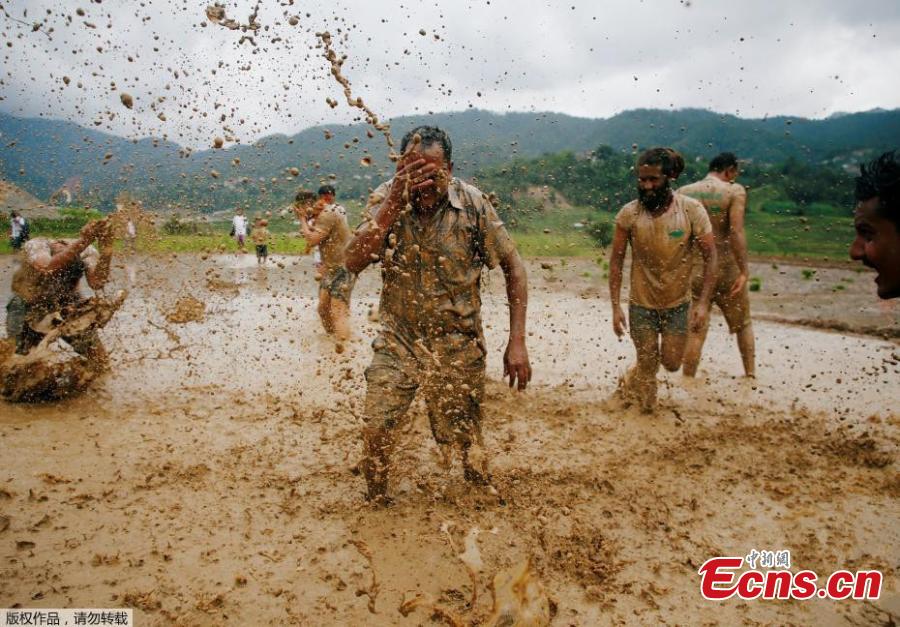 To celebrate the annual agricultural festival of Asar Pandra, or National Paddy Day, Nepalese farmers played soccer and soaked themselves in water and mud in central Nepal’s village of Lele. The festival, which falls on “Asar 15” of Nepalese calendar, marks the beginning of the rice plantation season. This year, the festival fell on Friday. On the day, farmers across the country dance, play with mud water and plant rice in the field in hope for a fruitful harvest season. Since rice is the staple food of Nepal, the country named the festival as the national Paddy Day since 2005 with the primary objective to improve rice productivity. (Photo/Aencies)
