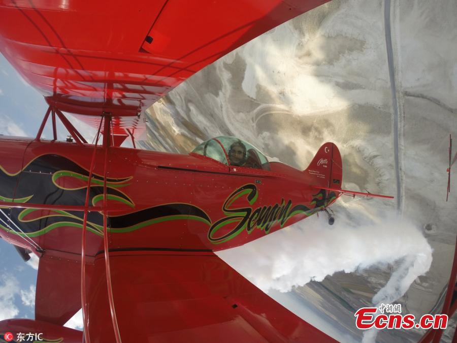 Semin Ozturk, Turkey\'s first professional female aerobatic pilot performs a demonstration flight with her \'Pitts S2-B\' plane that has Lycoming engine with 360 horsepower, at Necati Artan Facilities of Sivrihisar General Aviation Center in Eskisehir, Turkey, April 22, 2018. A 27-year-old aerobatic pilot, Semin experienced her first aerobatic flight performing when she was 12 years old with her father Ali Ismet Ozturk who is also an aerobatic pilot. On Sept. 19, 2015, she realized her first airshow at Sivrihisar General Aviation Center. Ozturk will attend the Aeromania Airshow which will take place between July 14-15 and host 35 aerobatic pilots from many countries. (Photo/IC)