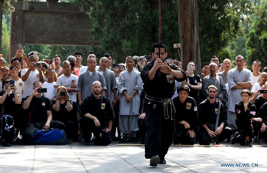 An American Kungfu enthusiast performs martial arts at Shaolin Temple on the Mount Songshan, central China\'s Henan Province, July 1, 2018. Over 200 Kungfu enthusiasts from America made a trip to the Shaolin Temple and performed martial arts with local monks. (Xinhua/Li An)