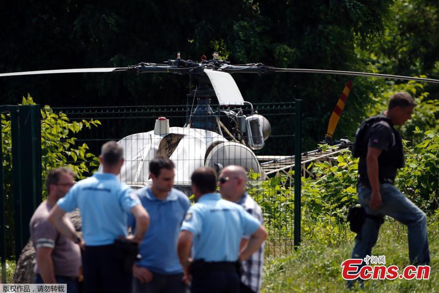 Photo taken on July 1, 2018 in Gonesse, north of Paris shows police near a French helicopter Alouette II abandoned by French armed robber Redoine Faid after his escape from prison in Reau. Redoine Faid was flown out of Réau prison with the help of three heavily-armed accomplices, security sources say. (Photo/Agencies)