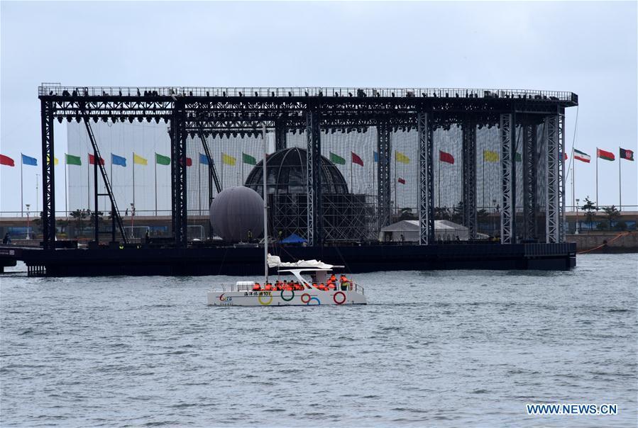 Visitors take a boat trip around the Olympic sailing center in Qingdao of east China\'s Shandong Province, July 1, 2018. The center, used as the conference hall during the 18th Shanghai Cooperation Organization (SCO) summit, after a brief remodification, was opened to the public from this Sunday. (Xinhua/Li Ziheng)