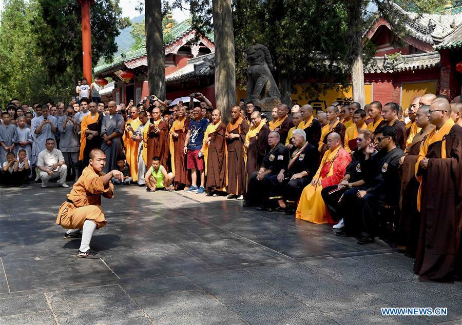 A monk performs martial arts at Shaolin Temple on the Mount Songshan, central China\'s Henan Province, July 1, 2018. Over 200 Kungfu enthusiasts from America made a trip to the Shaolin Temple and performed martial arts with local monks. (Xinhua/Li An)