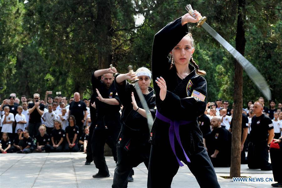 American Kungfu enthusiasts perform martial arts at Shaolin Temple on the Mount Songshan, central China\'s Henan Province, July 1, 2018. Over 200 Kungfu enthusiasts from America made a trip to the Shaolin Temple and performed martial arts with local monks. (Xinhua/Li An)