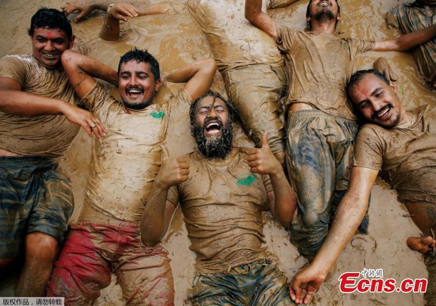 To celebrate the annual agricultural festival of Asar Pandra, or National Paddy Day, Nepalese farmers played soccer and soaked themselves in water and mud in central Nepal’s village of Lele. The festival, which falls on “Asar 15” of Nepalese calendar, marks the beginning of the rice plantation season. This year, the festival fell on Friday. On the day, farmers across the country dance, play with mud water and plant rice in the field in hope for a fruitful harvest season. Since rice is the staple food of Nepal, the country named the festival as the national Paddy Day since 2005 with the primary objective to improve rice productivity. (Photo/Aencies)