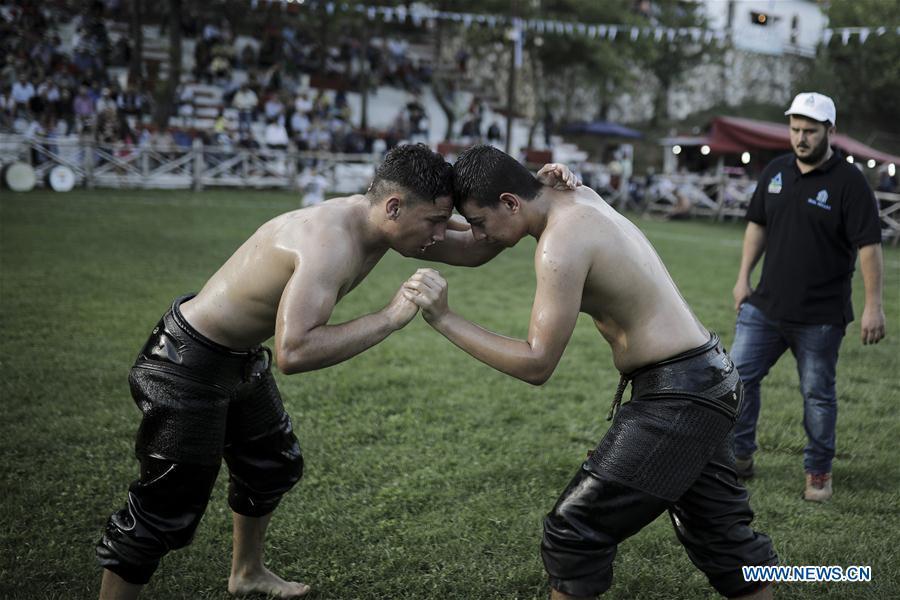 Photo taken on June 30, 2018, shows wrestlers participate in traditional oil wrestling competition in the village of Sohos, Thessaloniki, Greece. (Xinhua/ Dimitris Tosidis)