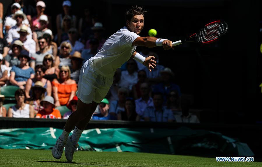 Dusan Lajovic of Serbia hits a return during the men\'s singles first round match against Roger Federer of Switzerland at the Championship Wimbledon 2018 in London, Britain, on July 2, 2018. Dusan Lajovic lost 0-3. (Xinhua/Tang Shi)