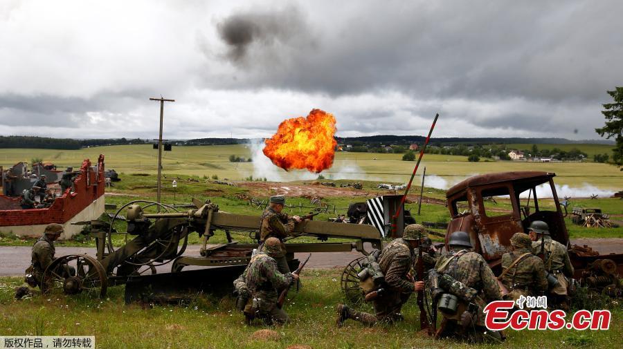 Military enthusiasts take part in a re-enactment of a World War II battle on the eve of Independence Day at the \