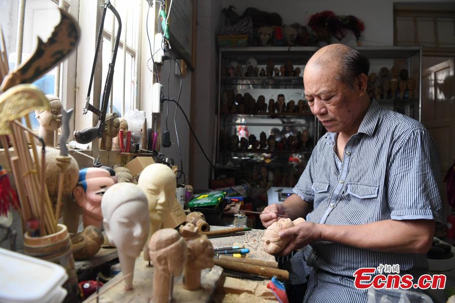 Folk artist Yang Yazhou makes a puppet head in his studio in Zhangzhou City, East China’s Fujian Province, July 1, 2018. Zhangzhou has a history of puppetry going back more than two thousand years. Yang represents the fifth generation of his family to be involved with Fuchun-style glove puppets show, an intangible cultural heritage. He began learning to carve puppet heads when he was nine years old, taught by several masters. Yang said it takes tens of steps to finish carving a puppet-head in about three days. Yang’s sister specializes in dressing the puppets, his brother in puppet performance. (Photo: China News Service/Zhang Bin)