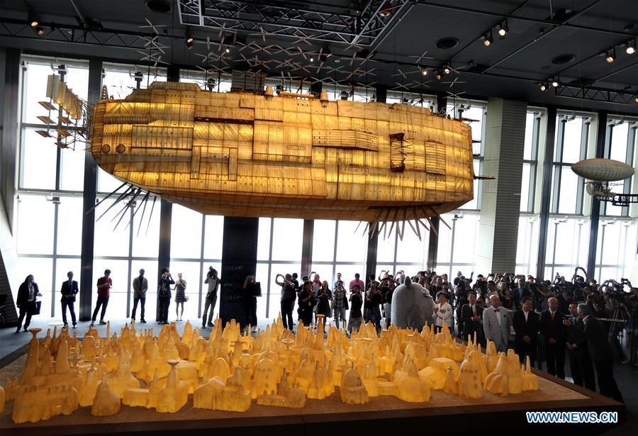 Visitors view a floating cartoon airship appearing in the Japanese animation adventure film \