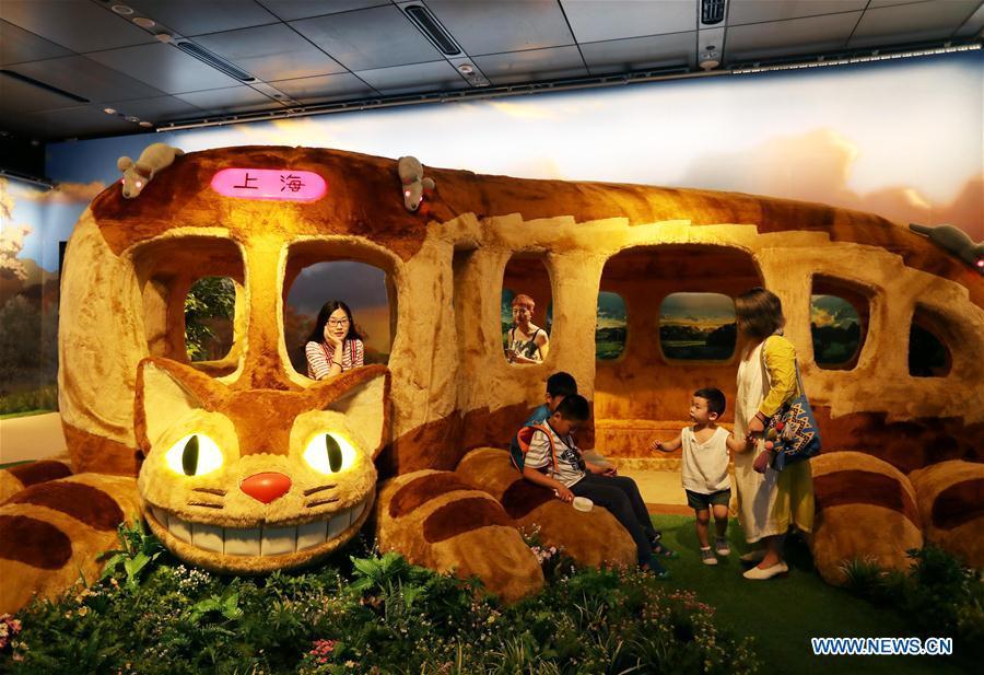 Visitors view the Catbus, a cartoon figure in the Japanese animation fantasy film \