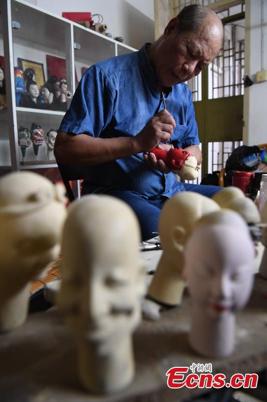 Folk artist Yang Yazhou paints the head of a puppet in his studio in Zhangzhou City, East China’s Fujian Province, July 1, 2018. Zhangzhou has a history of puppetry going back more than two thousand years. Yang represents the fifth generation of his family to be involved with Fuchun-style glove puppets show, an intangible cultural heritage. He began learning to carve puppet heads when he was nine years old, taught by several masters. Yang said it takes tens of steps to finish carving a puppet-head in about three days. Yang’s sister specializes in dressing the puppets, his brother in puppet performance. (Photo: China News Service/Zhang Bin)