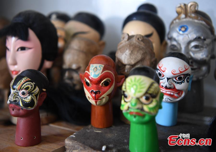 Folk artist Yang Yazhou shows his puppet head creations in his studio in Zhangzhou City, East China’s Fujian Province, July 1, 2018. Zhangzhou has a history of puppetry going back more than two thousand years. Yang represents the fifth generation of his family to be involved with Fuchun-style glove puppets show, an intangible cultural heritage. He began learning to carve puppet heads when he was nine years old, taught by several masters. Yang said it takes tens of steps to finish carving a puppet-head in about three days. Yang’s sister specializes in dressing the puppets, his brother in puppet performance. (Photo: China News Service/Zhang Bin)