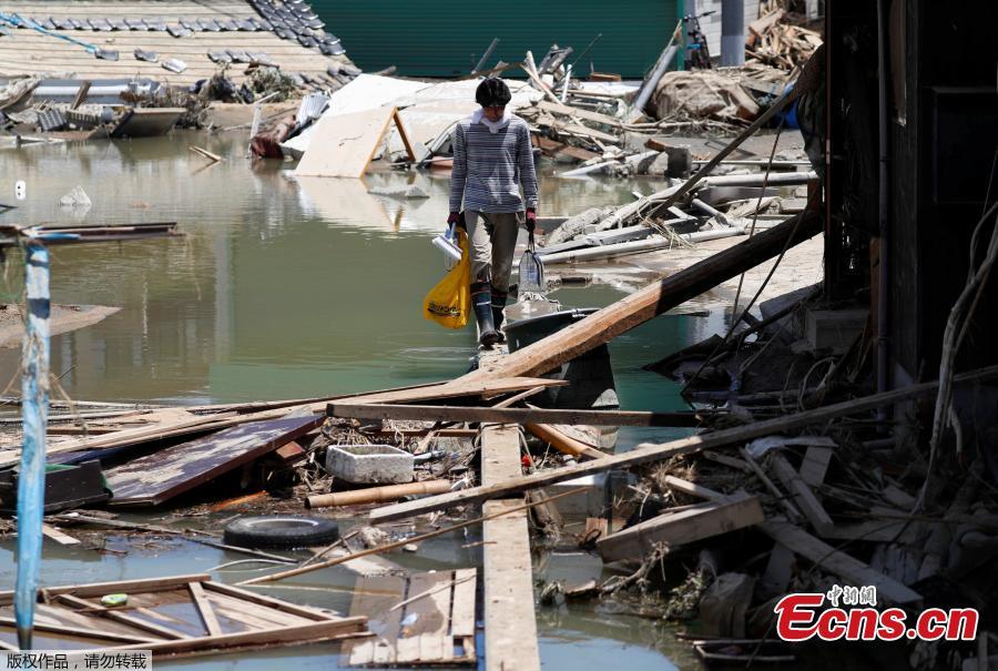 A local resident walks in a flooded area in Mabi town in Kurashiki, Okayama Prefecture, Japan, July 10, 2018. The death toll from widespread flooding and landslides rose to 126, according to Japanese authorities. (Photo/Agencies)