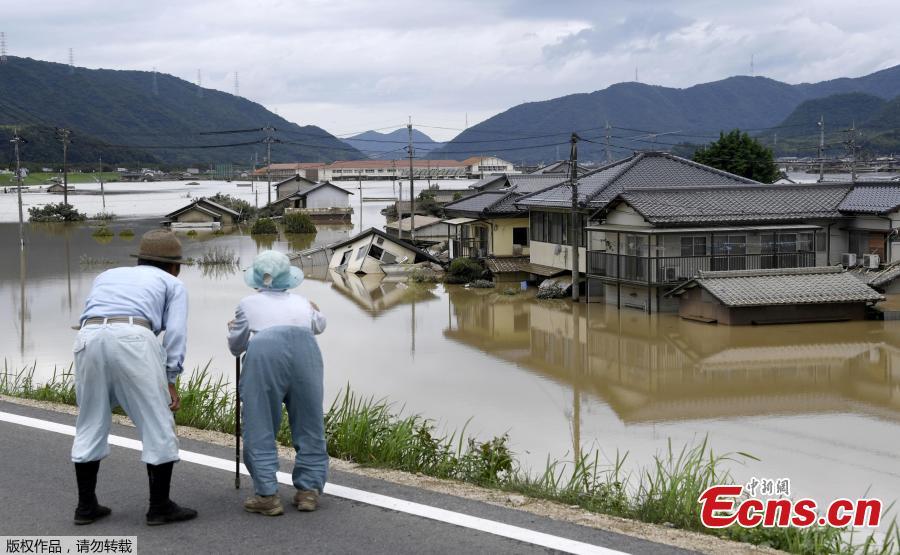 An elderly couple looks at a flooded area after heavy rain in Kurashiki, Okayama Prefecture, Japan, in this photo taken by Kyodo July 8, 2018. The death toll from widespread flooding and landslides rose to 126, according to Japanese authorities. (Photo/Agencies)