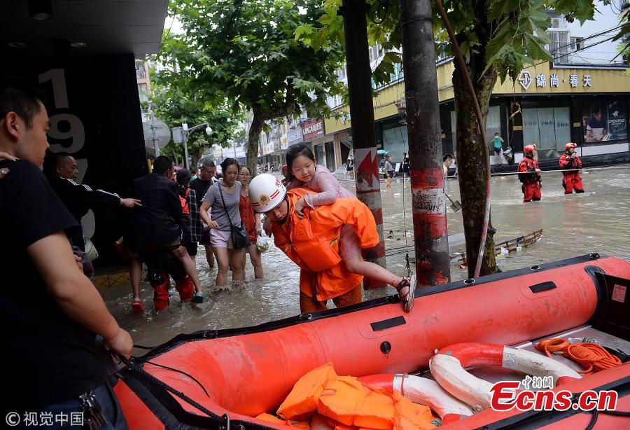 A rubber boat transports people on a flooded street in Jintang County, Southwest China’s Sichuan Province, July 12, 2018, after heavy rain. (Photo/VCG)