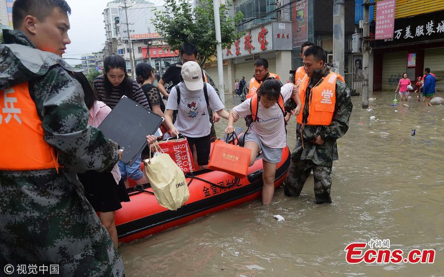 A rubber boat transports people on a flooded street in Jintang County, Southwest China’s Sichuan Province, July 12, 2018, after heavy rain. (Photo/VCG)