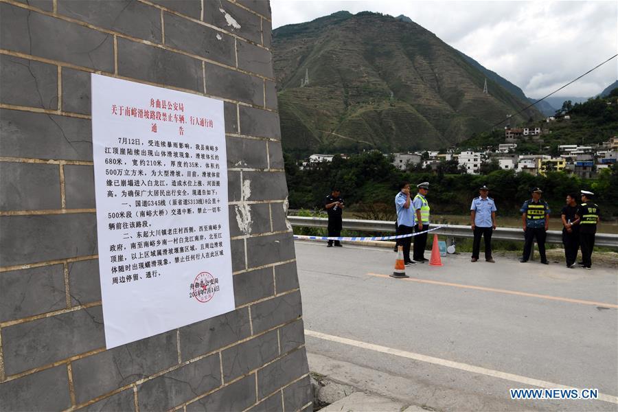 Road access to flood-hit areas is blocked due to traffic control in Nanyu Town of Zhouqu County, northwest China\'s Gansu Province, July 15, 2018. Emergency relief supplies have been sent to severely flooded areas in Zhouqu County and rescue work has been carried out here. Heavy rainstorms triggered a landslide Thursday in Zhouqu County, but no casualties have been reported. (Xinhua/Fan Peishen)