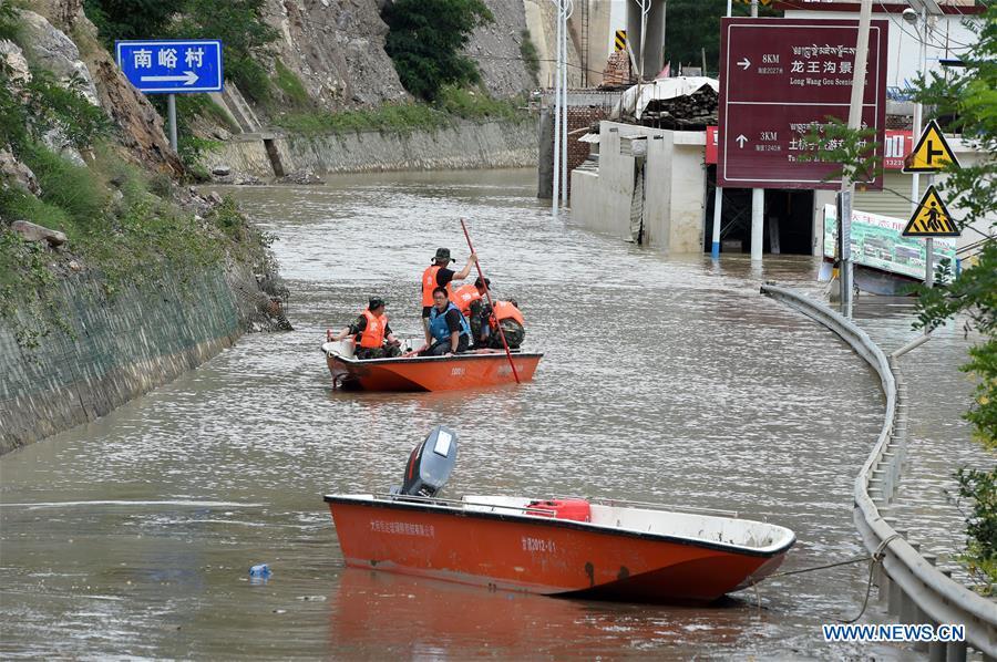 Rescuers work in Nanyu Town of Zhouqu County, northwest China\'s Gansu Province, July 15, 2018. Emergency relief supplies have been sent to severely flooded areas in Zhouqu County and rescue work has been carried out here. Heavy rainstorms triggered a landslide Thursday in Zhouqu County, but no casualties have been reported. (Xinhua/Fan Peishen)