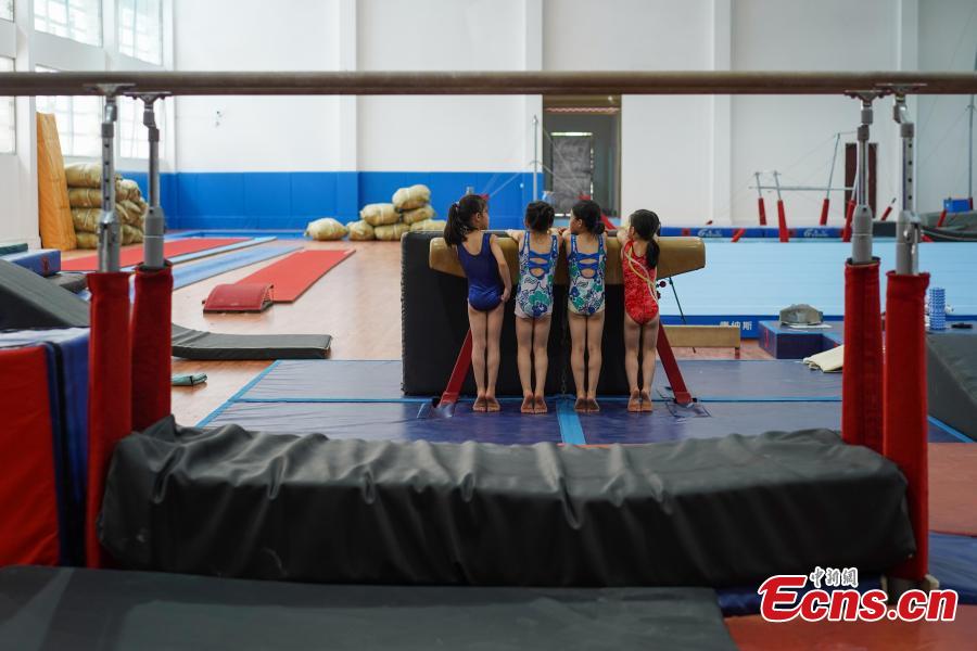 Students train at the Amateur Children\'s Gymnastics Training School in Rongjiang County, Southwest China’s Guizhou Province, July 16, 2018. There are 60 children taking part in gymnastics training at the school during their spare time. Since 1972, the county has sent 21 athletes to the provincial gymnastics and gymnastics trampoline teams, among whom six later became national team members. The county is home to Liu Rongbing, who won a gold medal for the men\'s team in the 2014 World Artistic Gymnastics Championships. (Photo: China News Service/He Junyi)