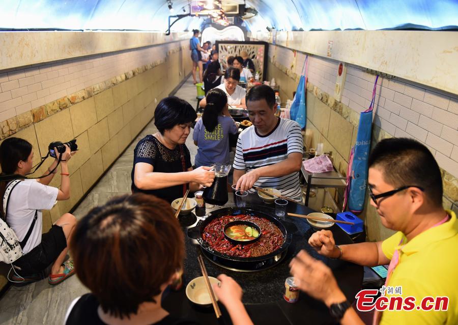 A popular hot pot restaurant inside a former air-raid shelter in Southwest China’s Chongqing Municipality, July 17, 2018. Authorities in Chongqing have allowed for the development of air-raid shelters, and they have been converted into wine cellars, restaurants and gas stations. The venues become especially popular in summer as it’s usually cool inside. (Photo: China News Service/Zhou Yi)
