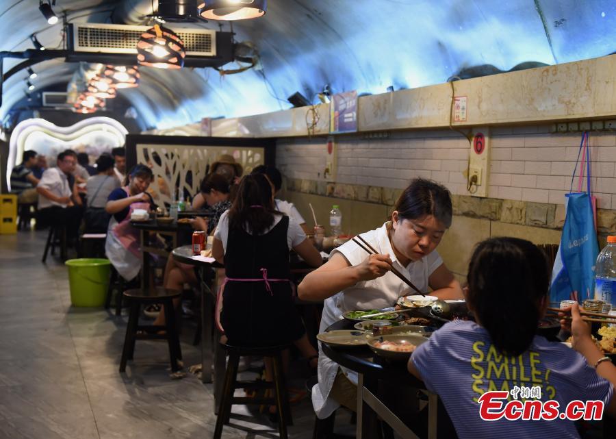 A popular hot pot restaurant inside a former air-raid shelter in Southwest China’s Chongqing Municipality, July 17, 2018. Authorities in Chongqing have allowed for the development of air-raid shelters, and they have been converted into wine cellars, restaurants and gas stations. The venues become especially popular in summer as it’s usually cool inside. (Photo: China News Service/Zhou Yi)