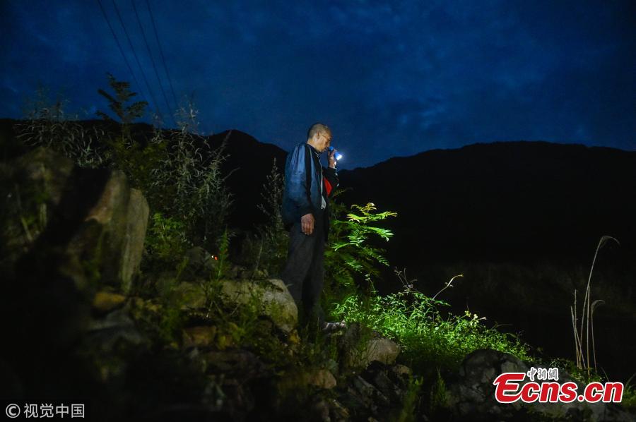 Mou Huaiqing, 65, patrols a valley at night in Dujiangyan City, Southwest China’s Sichuan Province. For the past nine years, since the deadly May 12 earthquake in 2008, Mou and his colleagues have been responsible for 24-hour monitoring of the valley from May to October for signs of potential landslides that could pose a threat to local villagers. They check for any cracks on mountain slopes, for example. Mou helped evacuate 300 residents and tourists in a timely manner as he sounded an alarm to warn of a landslide in August 2010. The team has sounded warnings for a dozen geological hazards. (Photo/VCG)