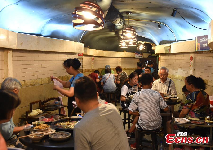 A popular hot pot restaurant inside a former air-raid shelter in Southwest China’s Chongqing Municipality, July 17, 2018. Authorities in Chongqing have allowed for the development of air-raid shelters, and they have been converted into wine cellars, restaurants and gas stations. The venues become especially popular in summer as it’s usually cool inside. (Photo: China News Service/Zhou Yi)